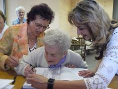Paní Marie Harasimová (92 let) se&nbsp;podepisuje do&nbsp;pamětní knihy obce.